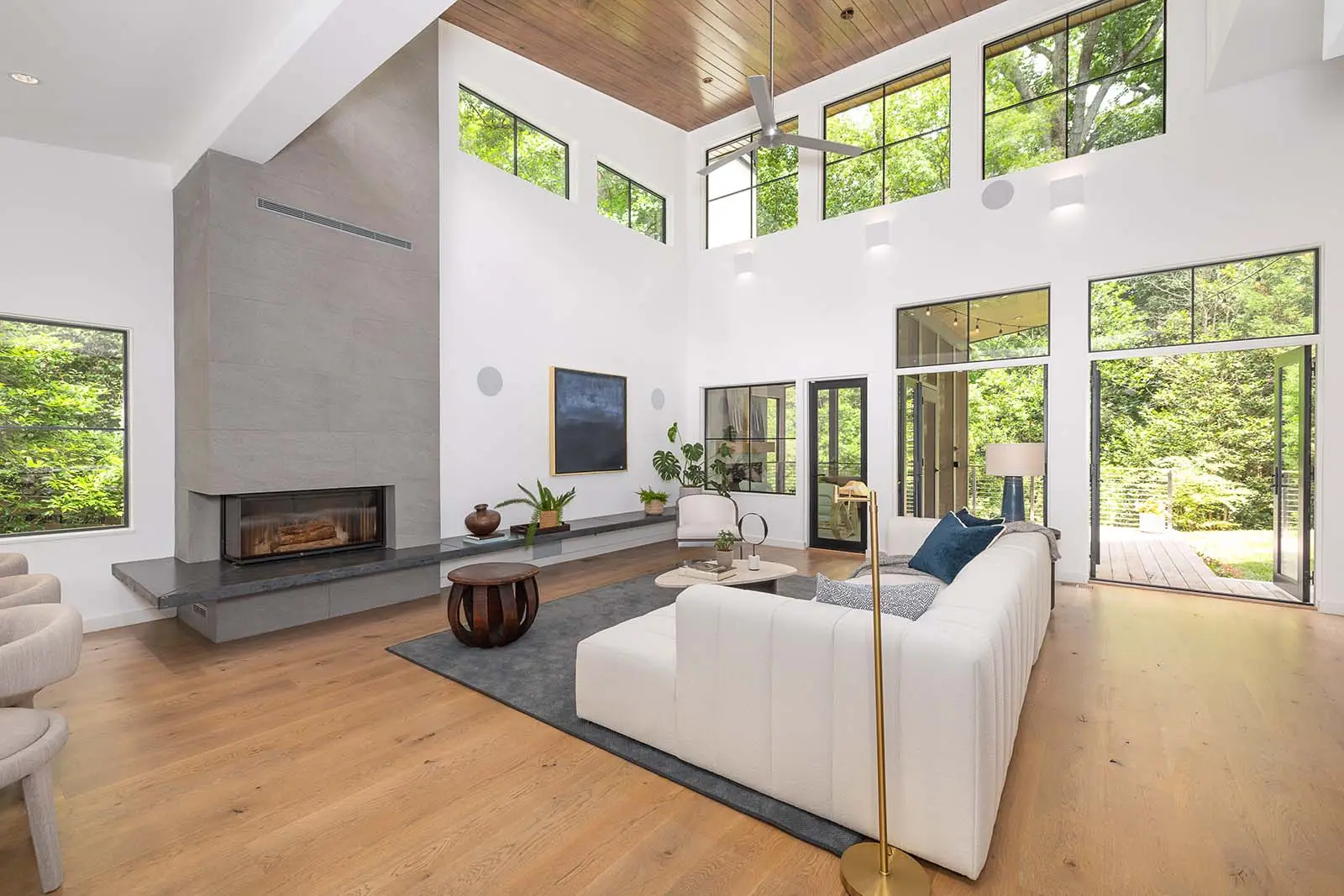 Double-height living room in Decatur modern custom home with fireplace and large windows