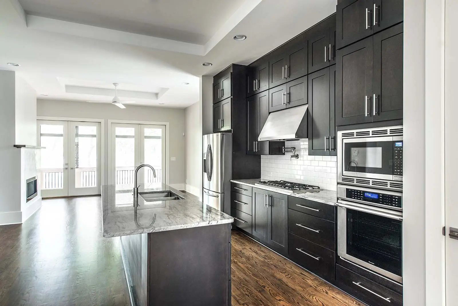Kitchen with island and dark cabinetry in Oakhurst custom home