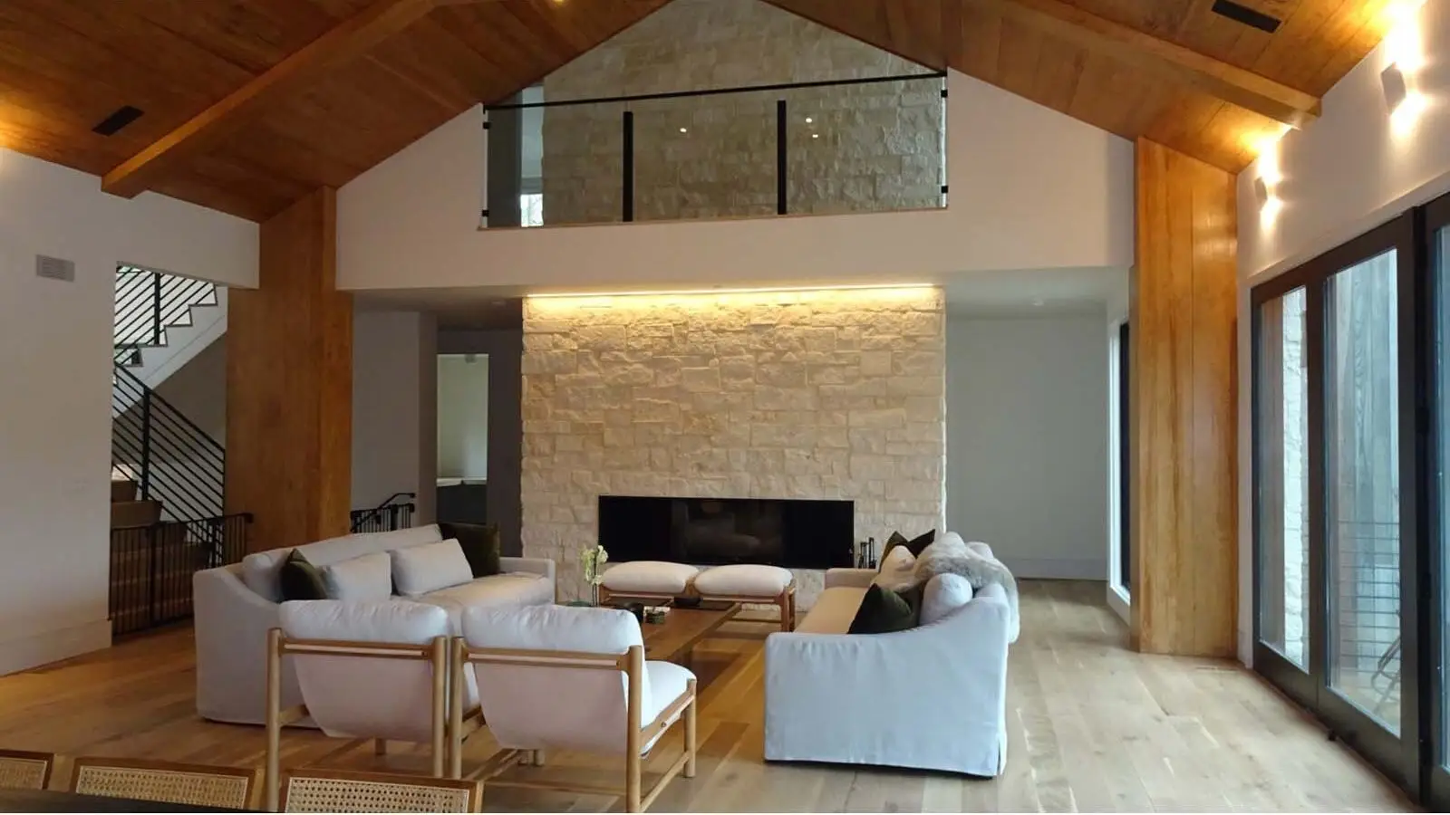 Living room in Lake Burton luxury custom home with limestone fireplace and wood ceiling
