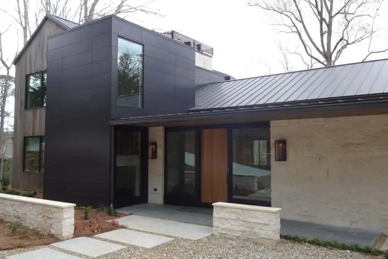 Lake Burton luxury custom home exterior with limestone, wood siding and metal roof