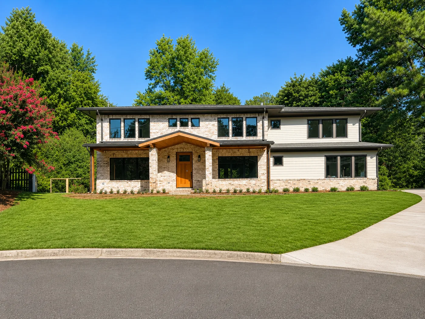 Completed luxury home reconstruction in Dunwoody, Georgia with brick, siding and modern black windows
