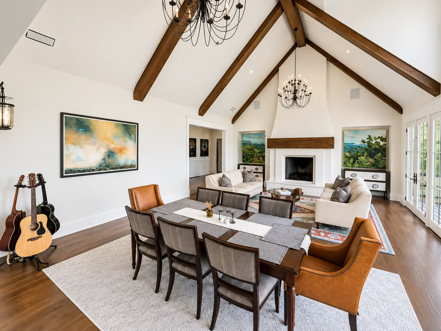 Vaulted great room and dining area with exposed wood beams, fireplace, and French doors in a custom home at Waterfall Club on Lake Burton, Georgia.
